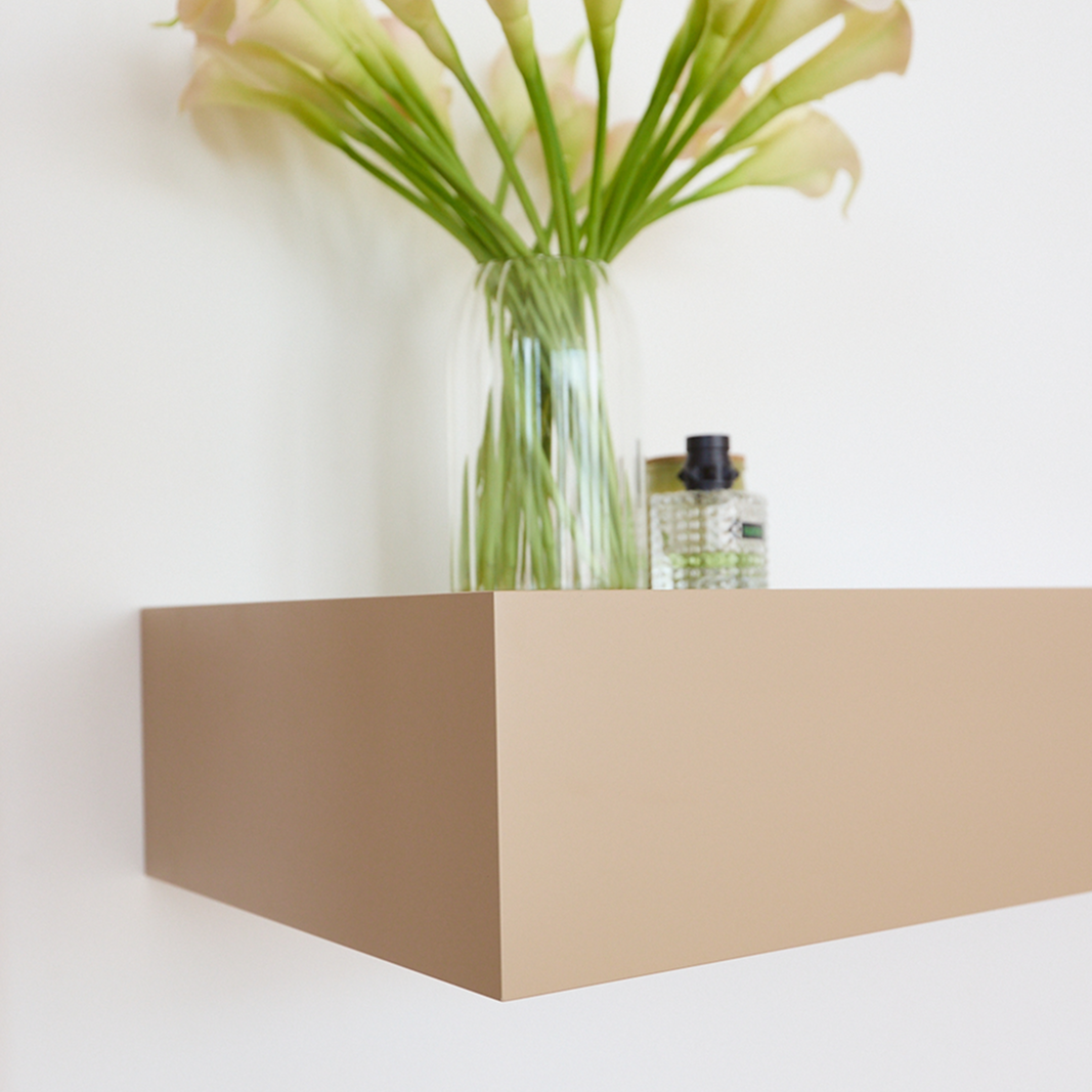 Close-up of beige A14 floating wall table corner and smooth painted MDF finish