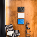 Three HIDDO D01 wall art designs with hidden storage displayed vertically in a modern interior.