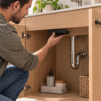 B01 magnetic hidden storage box being installed inside a wooden cabinet