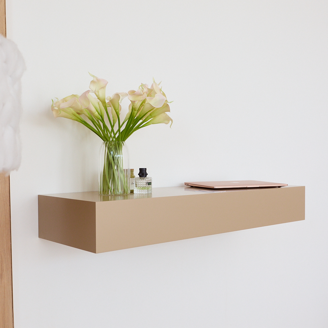 A14 floating wall table with hidden RFID drawer in beige finish, styled with flowers and laptop