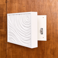 Side view of white D01 wall art opened to reveal the hidden compartment and concealed locking mechanism.