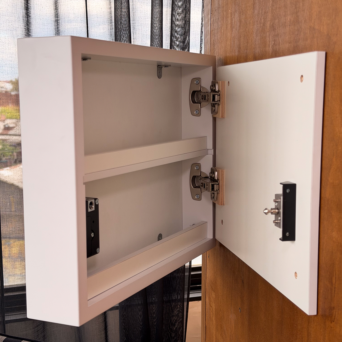 Close-up of the open D01 hidden storage compartment with hinges and RFID locking mechanism.