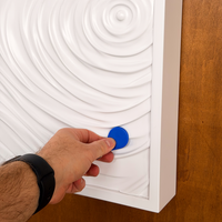 Opening the white D01 hidden wall storage with an RFID key fob.