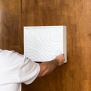 Man unlocking the D01 concealed wall compartment using an RFID access card.