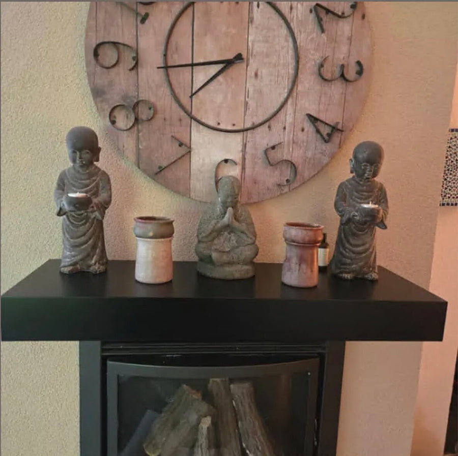 Black floating Hiddo shelf with decorative figurines