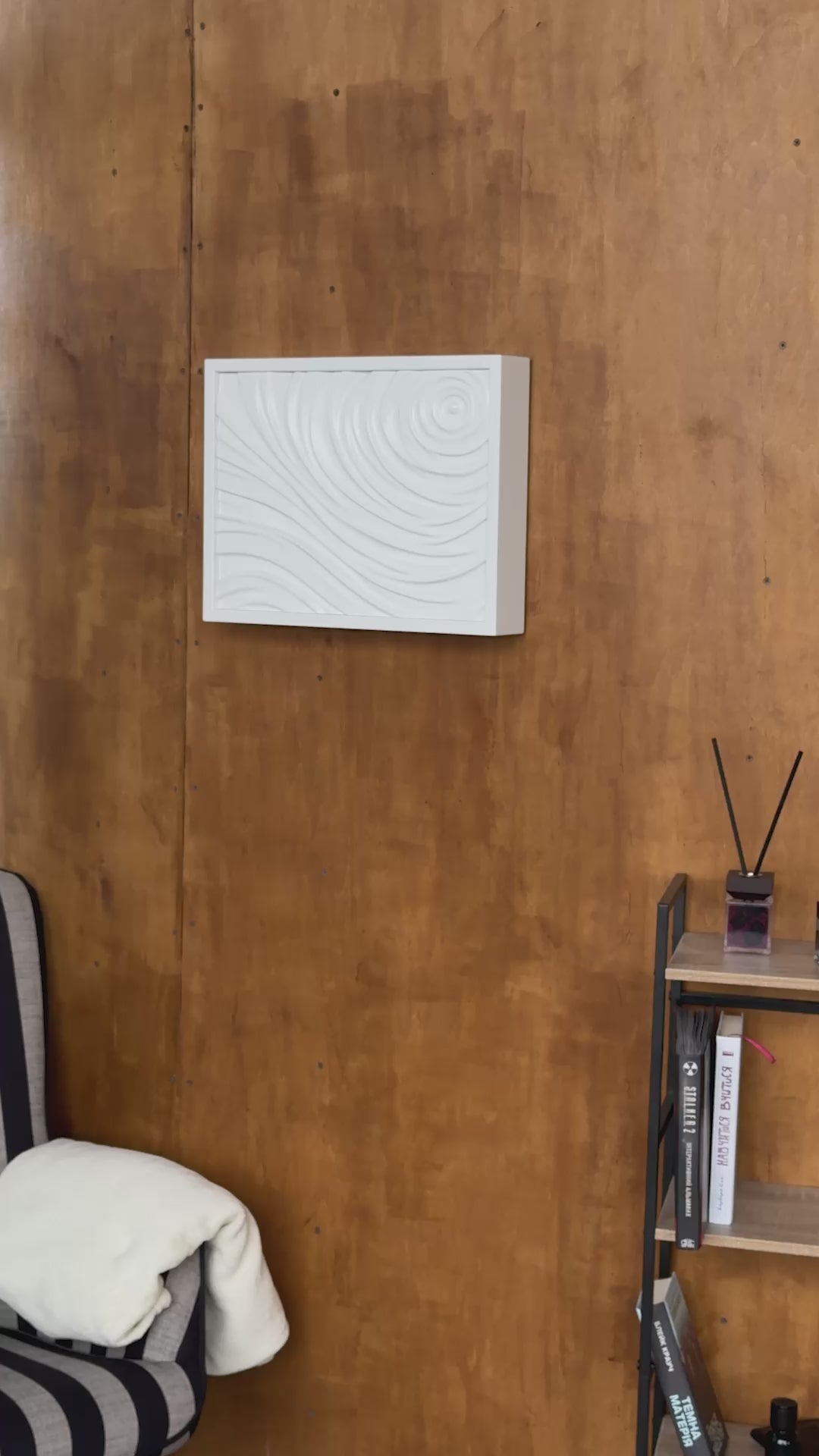 Display of white wall decor D01 on a wooden panel. Man unlocking the D01 concealed wall compartment using an RFID access card and opened it.