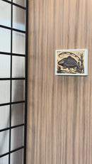 The video showcases the D01 Fisherman wall decor, showing how it looks on a wooden wall panel and how the hidden compartment opens using a contactless RFID key card. Inside the concealed storage area, valuables and cash are securely stored.